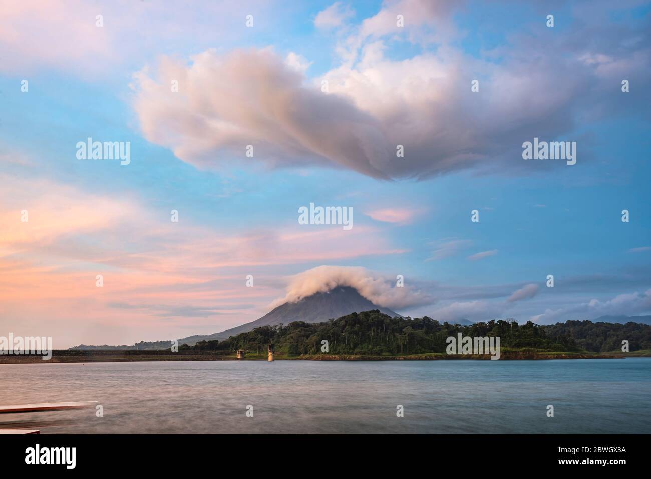 Arenal Volcano and Arenal Lake at sunset, near La Fortuna, Alajuela Province, Costa Rica Stock Photo