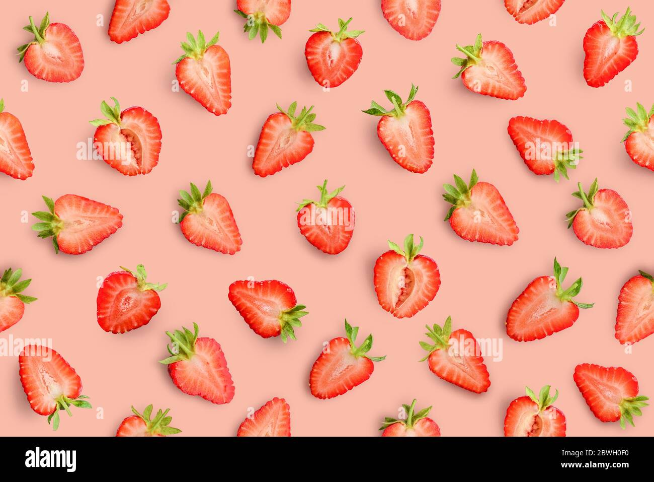 Strawberry slices as seamless pattern on red background Stock Photo