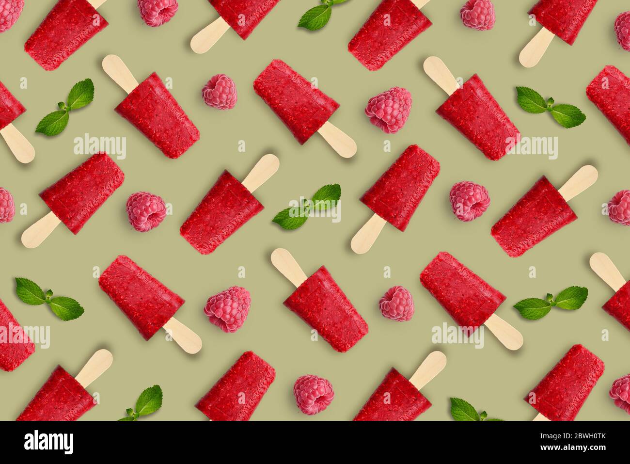 Pattern from raspberry popsicle on green background Stock Photo