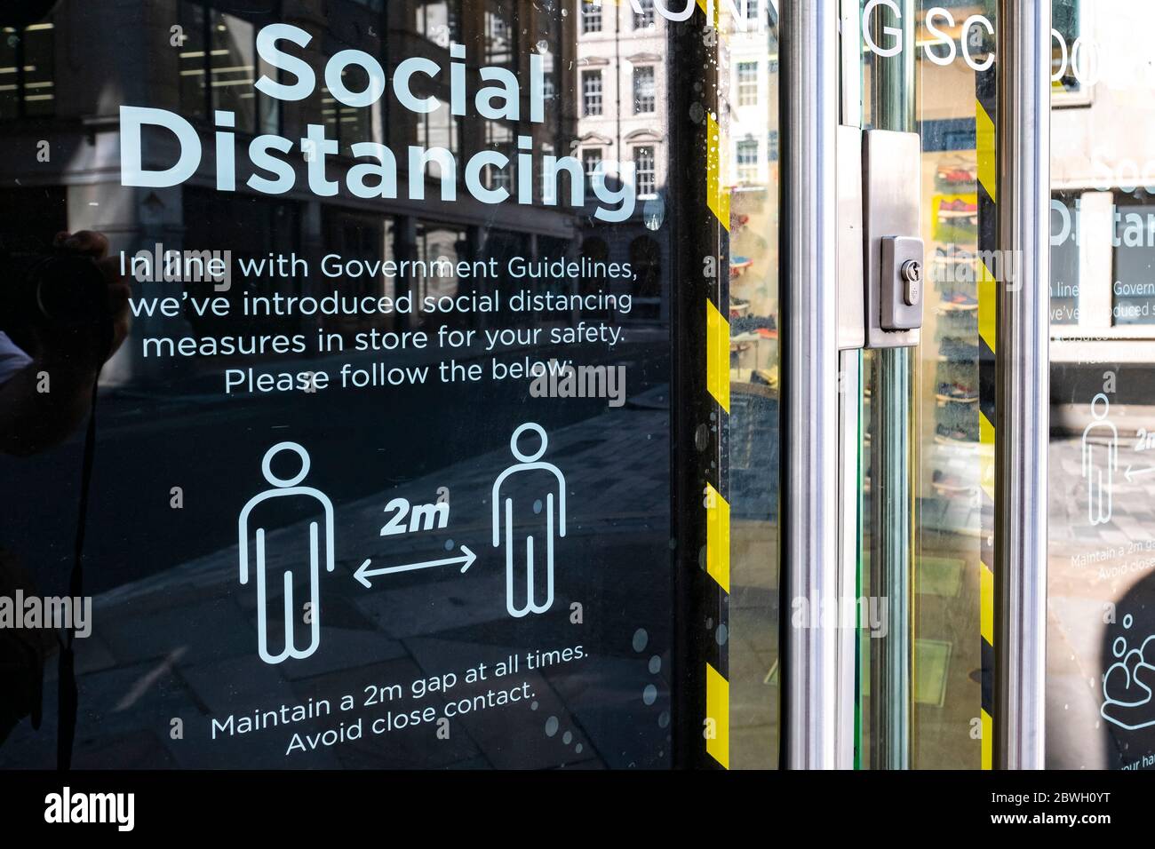 London-June 2020: Social distancing guidance on retail shop window Stock Photo