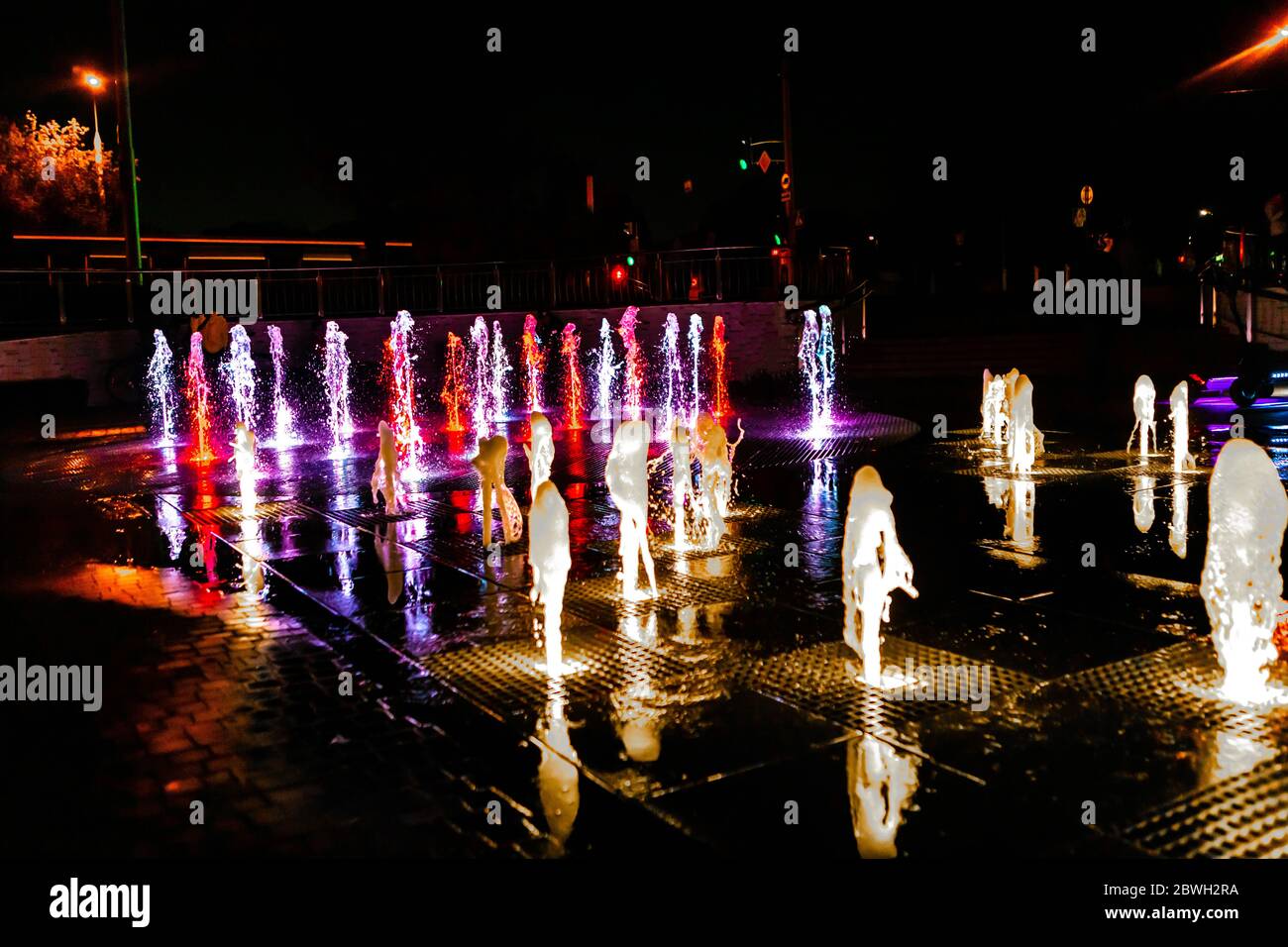 Bright and colorful fountain at night street Stock Photo - Alamy