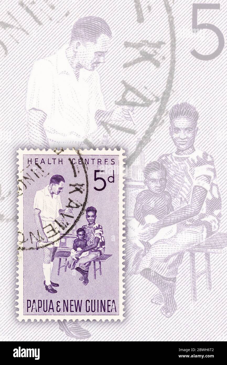 SEATTLE WASHINGTON - May 30, 2020:  Man, woman and child on Health Centres 1964  stamp of Papua and New Guinea.  Scott # 184. Stock Photo