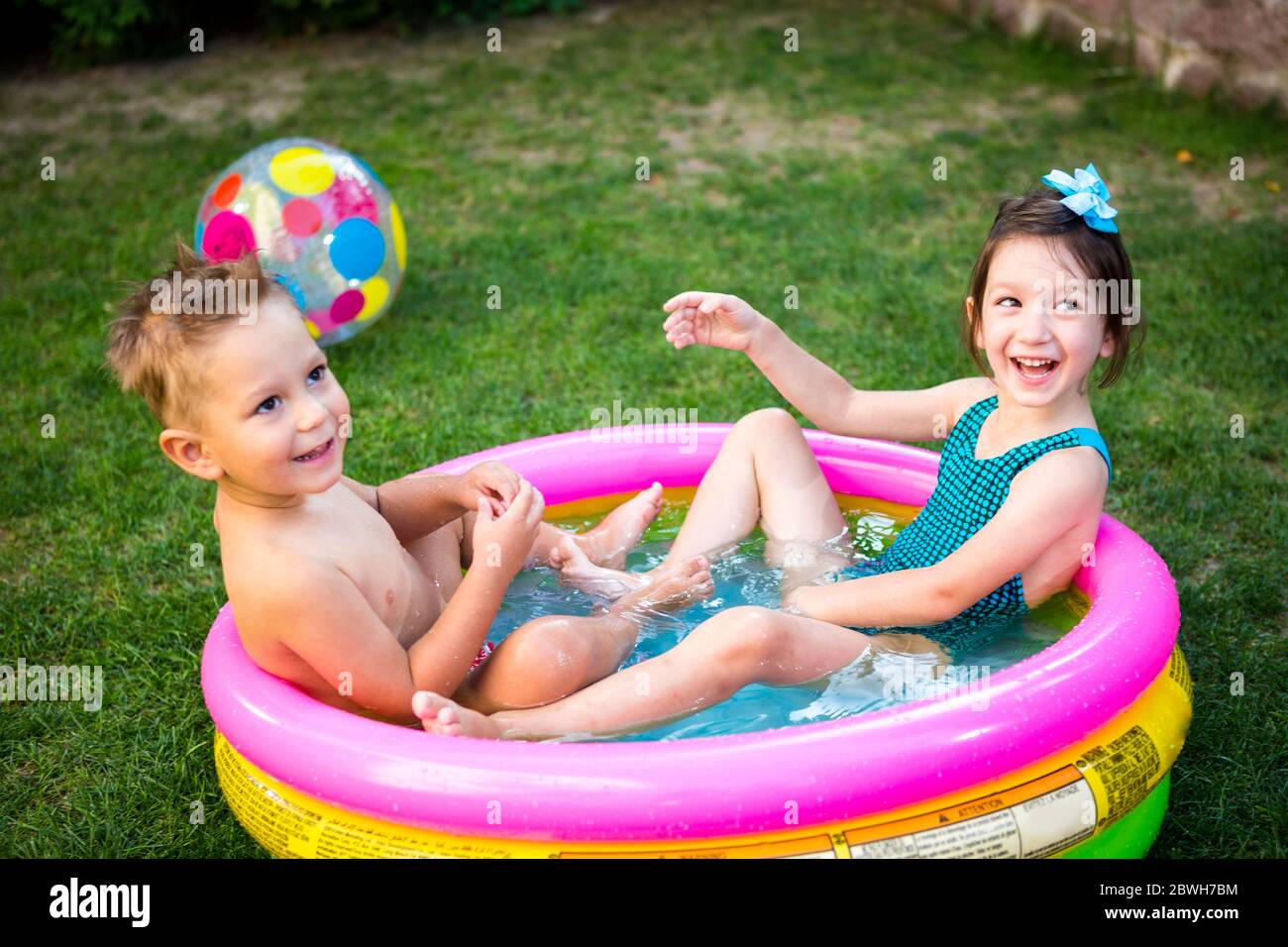 Inflatable Pool. Summer vacation concept. Games in water. Leisure in back  yard. children bathing in an inflatable outdoor swimming pool and play Color  Stock Photo - Alamy