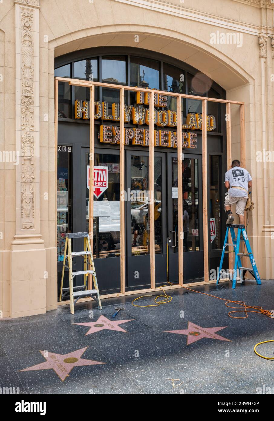 Los Angeles, USA, 1st June, 2020. Worker preemptively constructing wooden protective wall in front of the entrance to a gift shop called The Hollywood Experience, in response to looting and vandalism during the George Floyd protests. Credit: Jim Newberry/Alamy Live News. Stock Photo