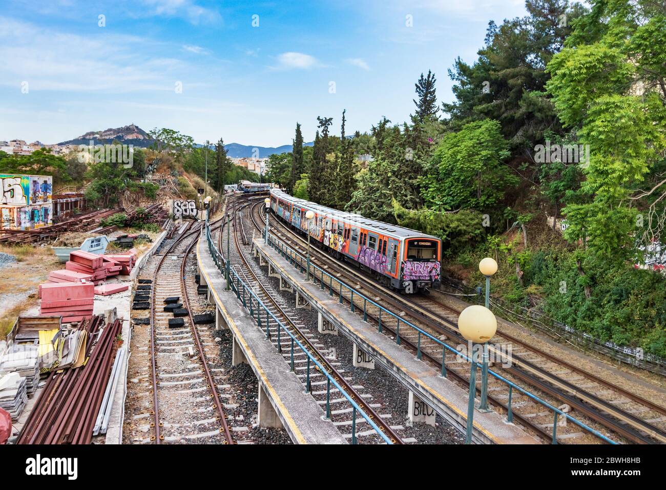 Perspective view of a Greek sub-urban train running on the railways next the Thissio Station, Athens. Stock Photo