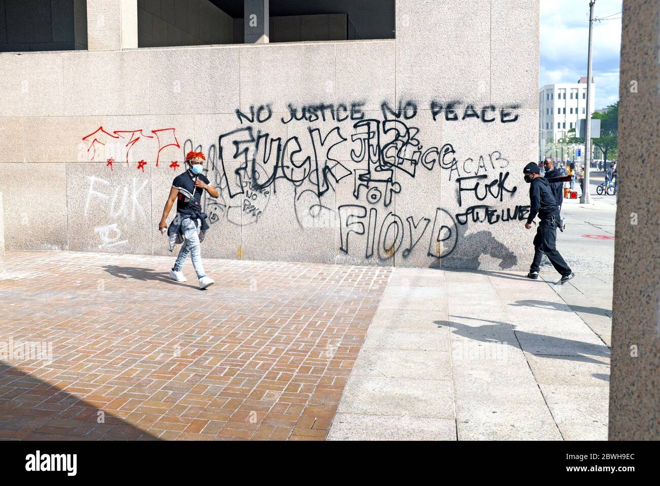 Protesters graffiti a wall at the Cleveland Justice Center in Cleveland, Ohio during George Floyd protests on May 30, 2020. Stock Photo
