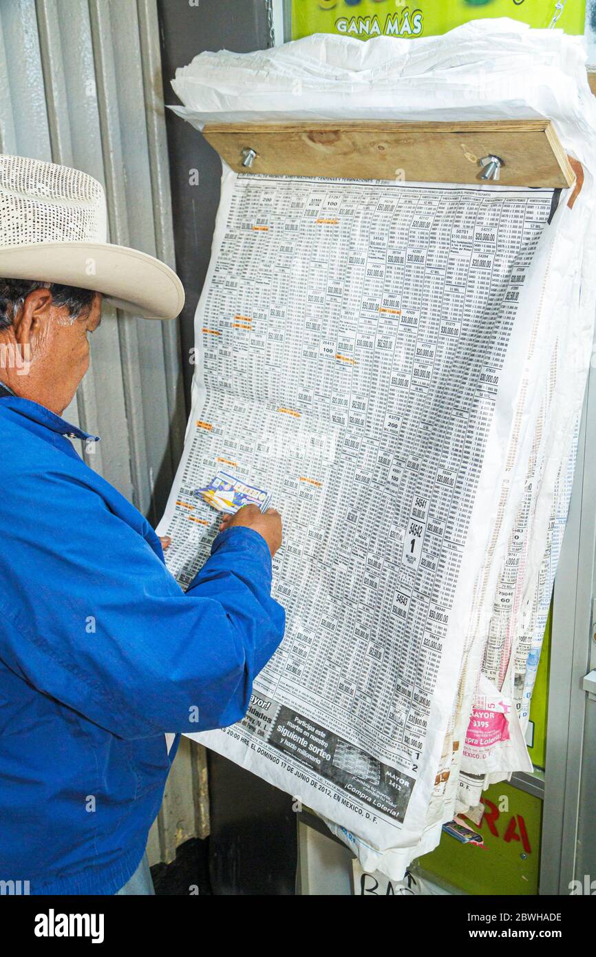 Mexico City,México Mexican,Metro,Insurgentes Station,Line 1,subway,train,STC,mass transit,Hispanic man men male,lottery post,results,checking winning Stock Photo