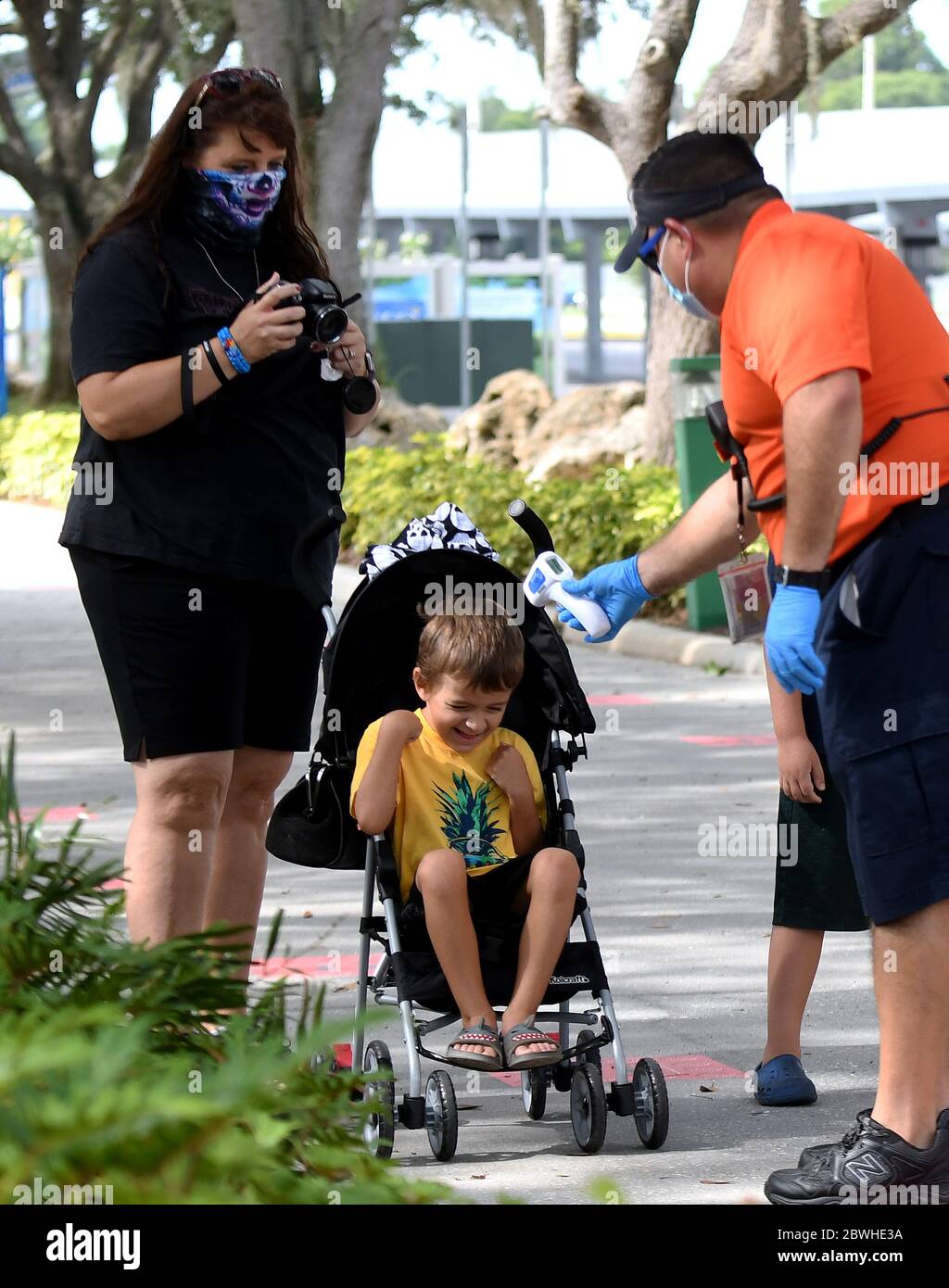 June 1, 2020 - Winter Haven, Florida, United States - A child in a stroller reacts as his temperature is checked at the entrance to LEGOLAND Florida on the day the theme park reopened to the public after closing in mid-March due to the coronavirus pandemic. Guests are now required to submit to temperature checks and the wearing of face coverings is recommended but not required. (Paul Hennessy/Alamy Live News) Stock Photo