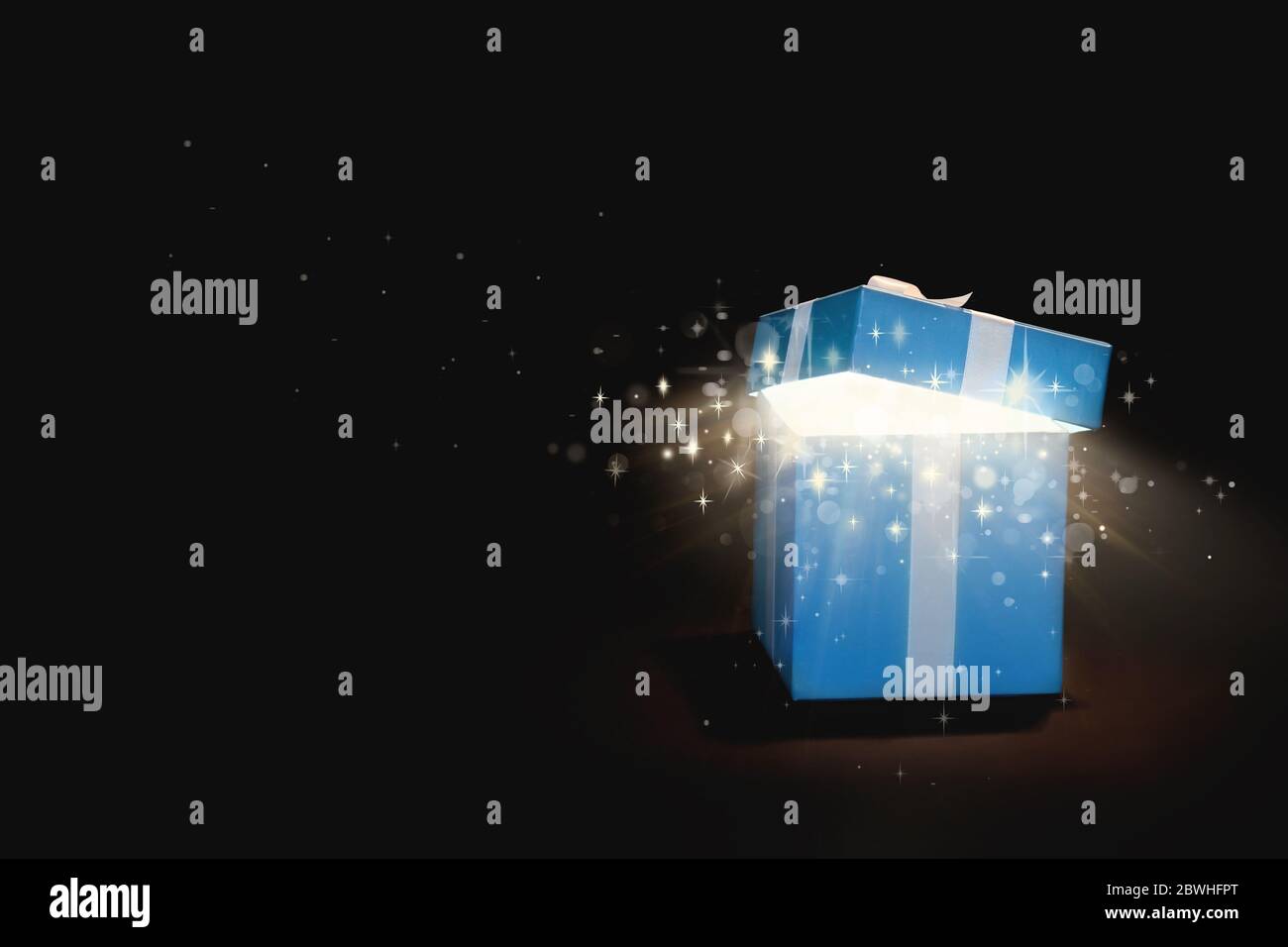 Beautiful magic gift box on dark background Stock Photo - Alamy