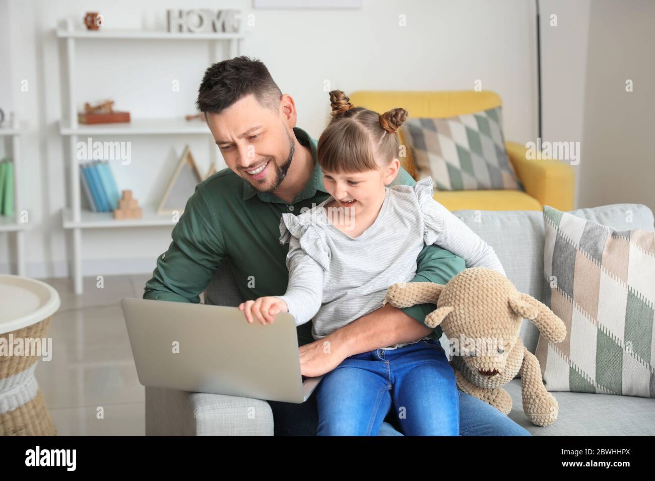 Working father with little daughter at home Stock Photo