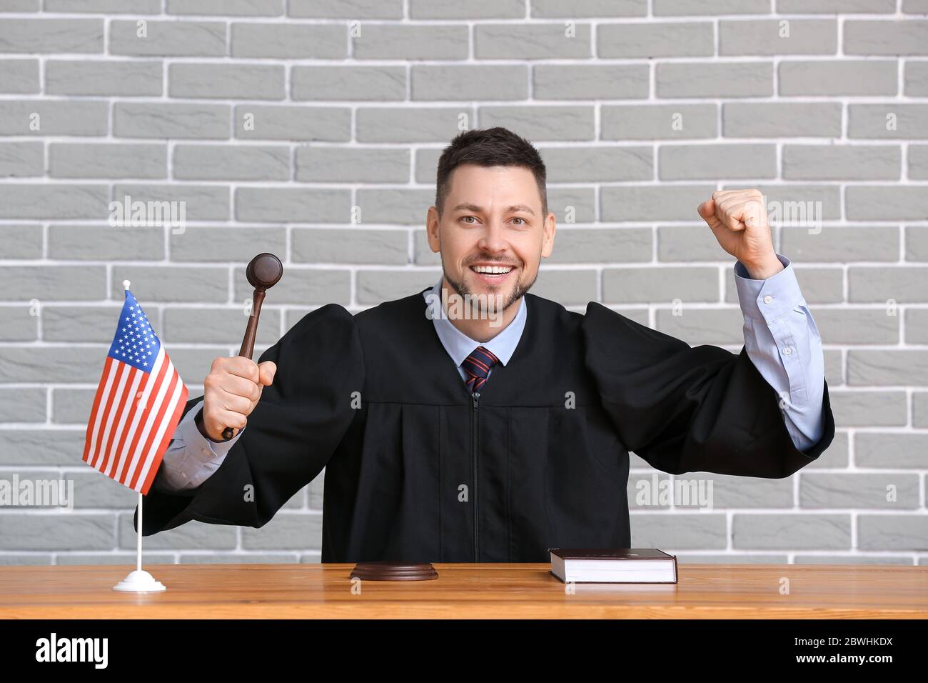 Happy male judge at table in courtroom Stock Photo Alamy