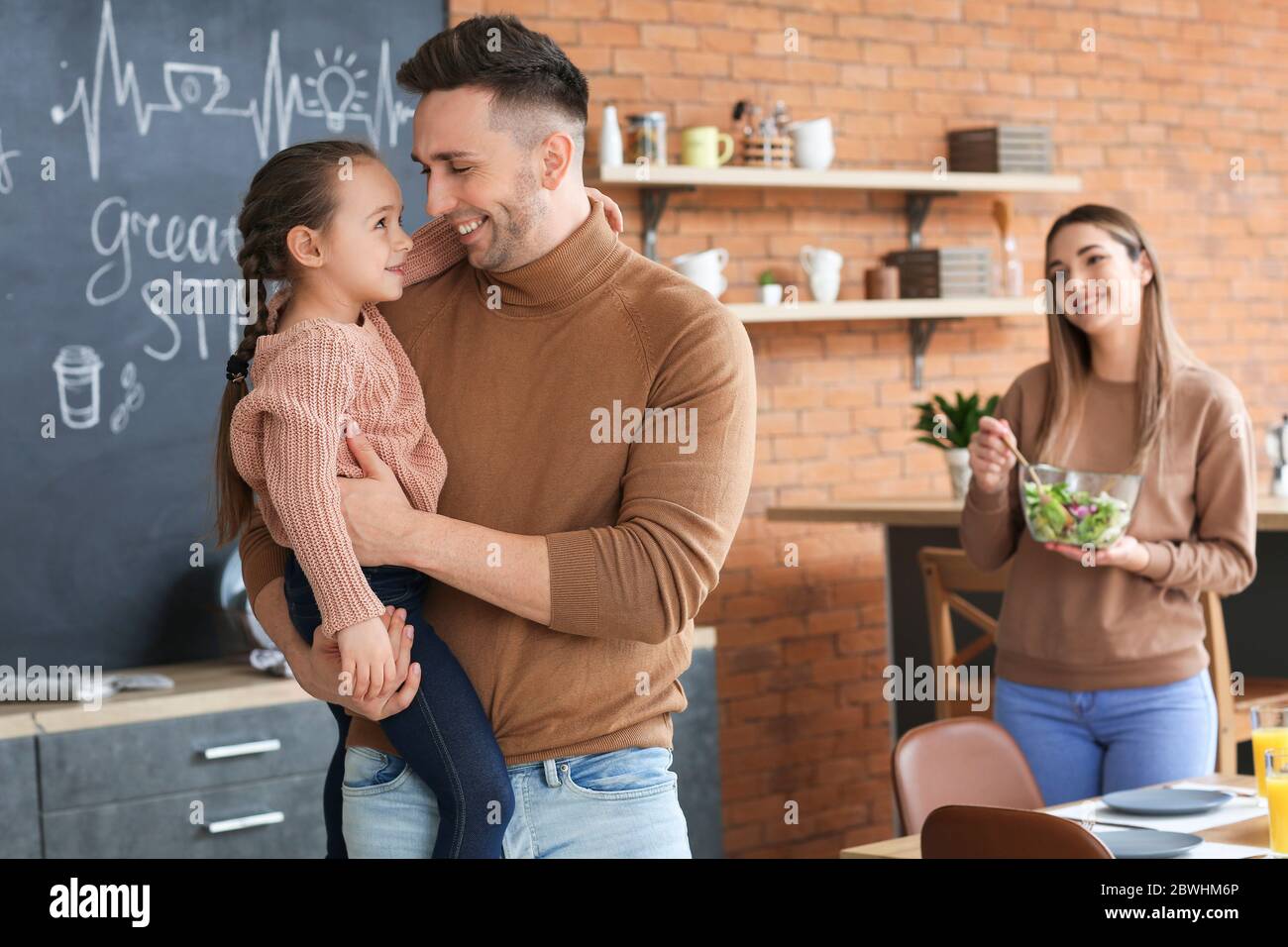 Happy family spending time together in kitchen Stock Photo