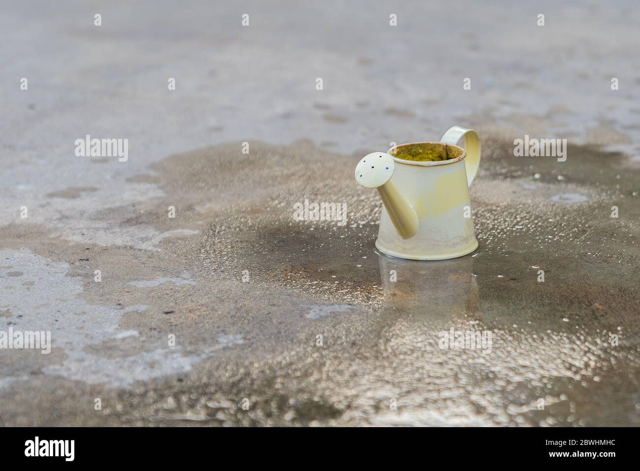 Small yellow watering bucket in vintage style. Stock Photo
