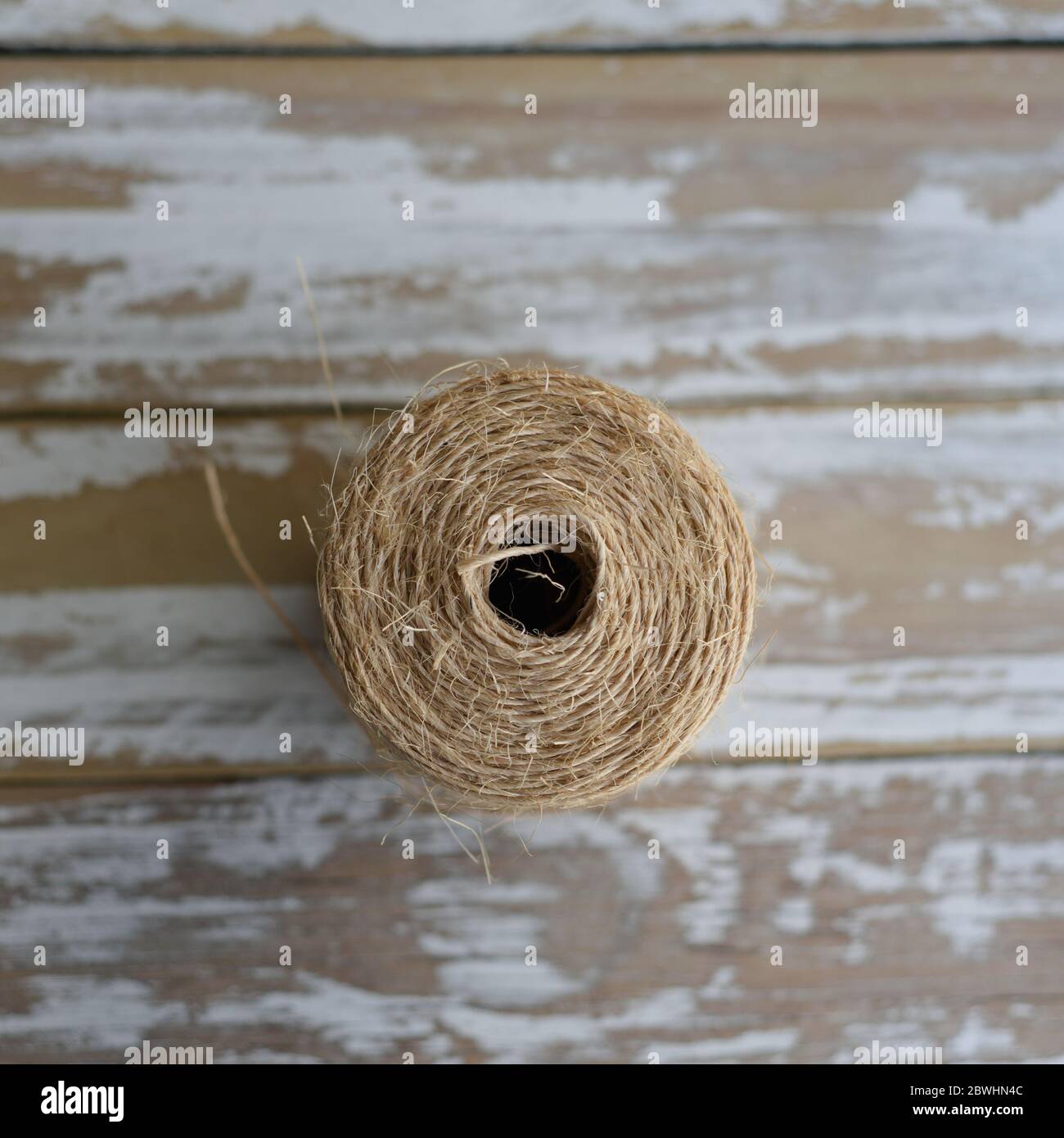 Roll of twine on distressed wood Stock Photo