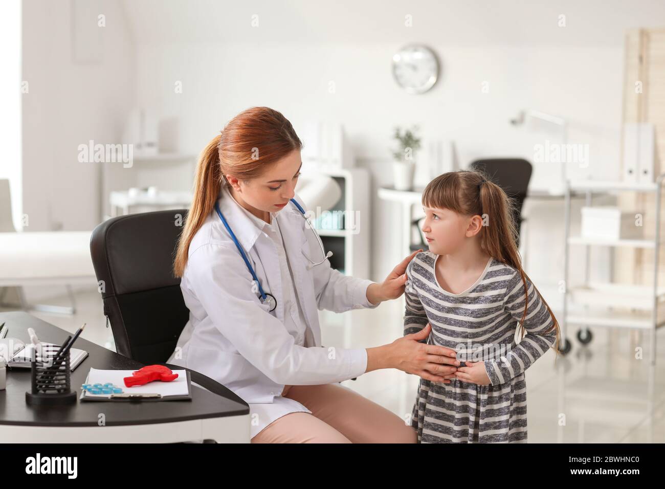 Gastroenterologist examining little girl in clinic Stock Photo Alamy