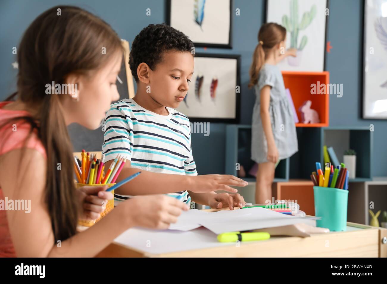 Cute children drawing at school Stock Photo - Alamy