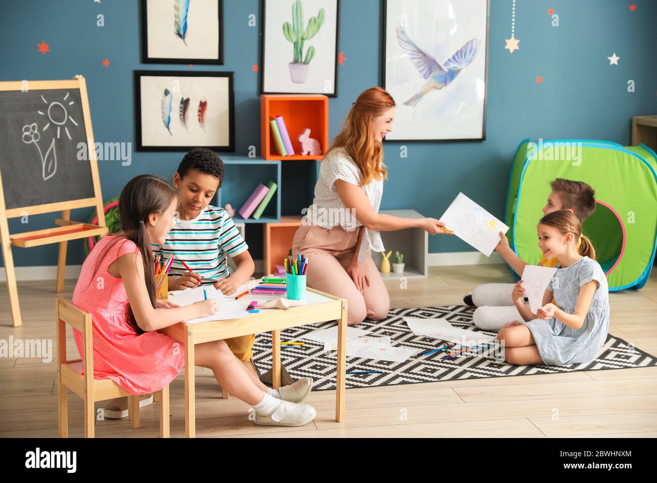 Cute children drawing at school Stock Photo - Alamy