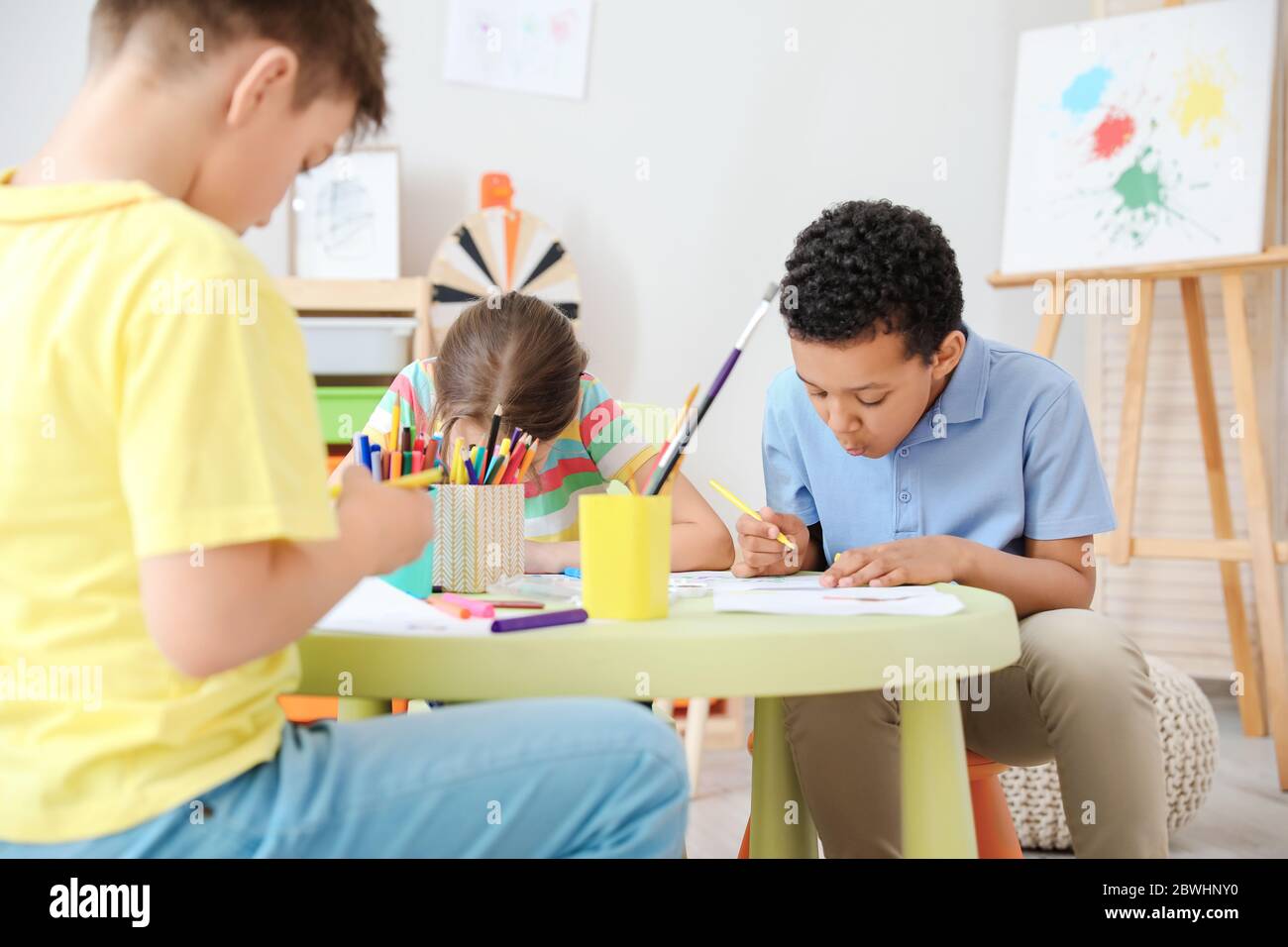 Cute children drawing at school Stock Photo - Alamy
