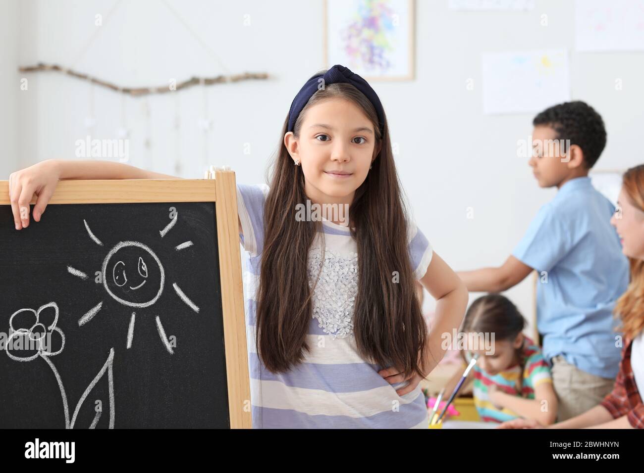Cute girl drawing at school Stock Photo - Alamy