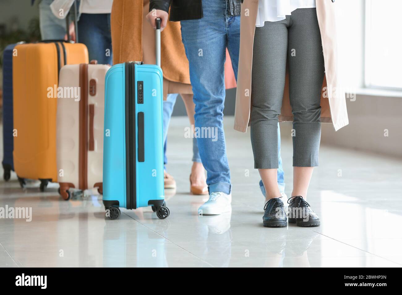 Please Wait In Line People waiting in line at the airport Stock Photo - Alamy