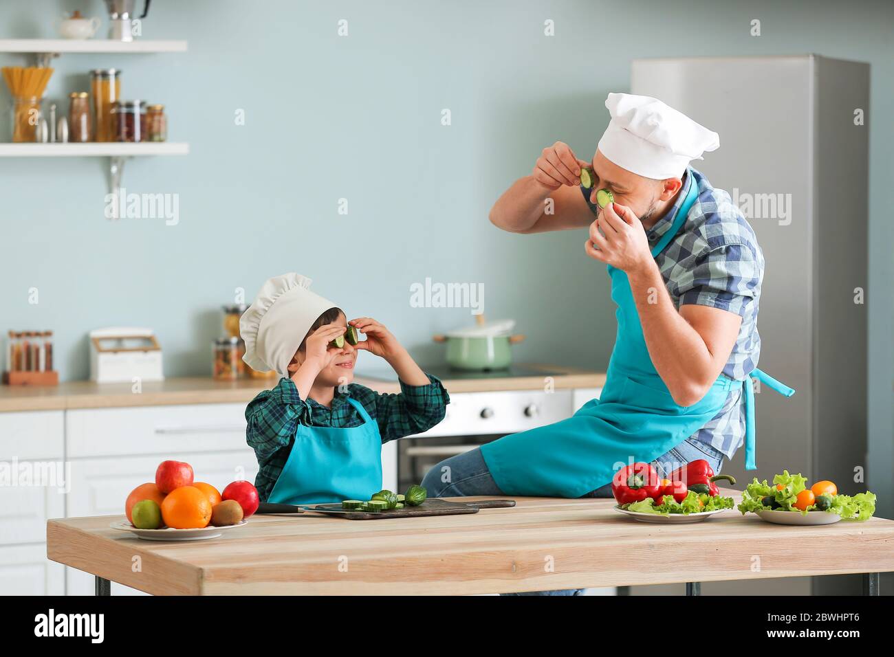 Father and his little son cooking in kitchen Stock Photo - Alamy