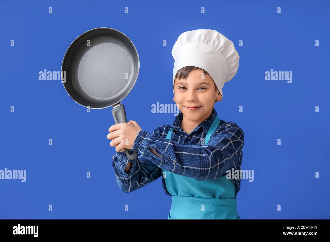 Portrait of little chef on color background Stock Photo - Alamy
