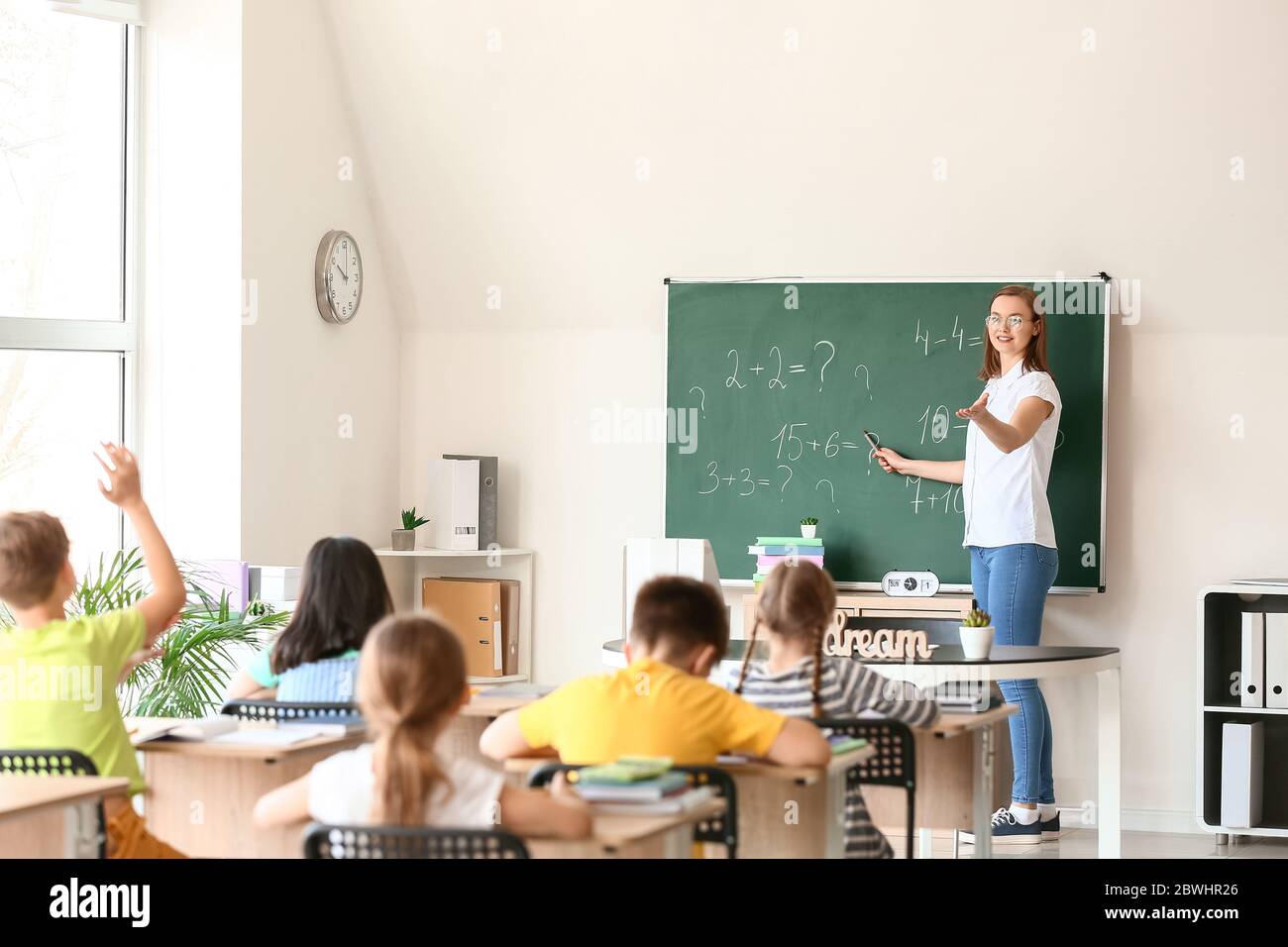 Math teacher conducting lesson in classroom Stock Photo - Alamy