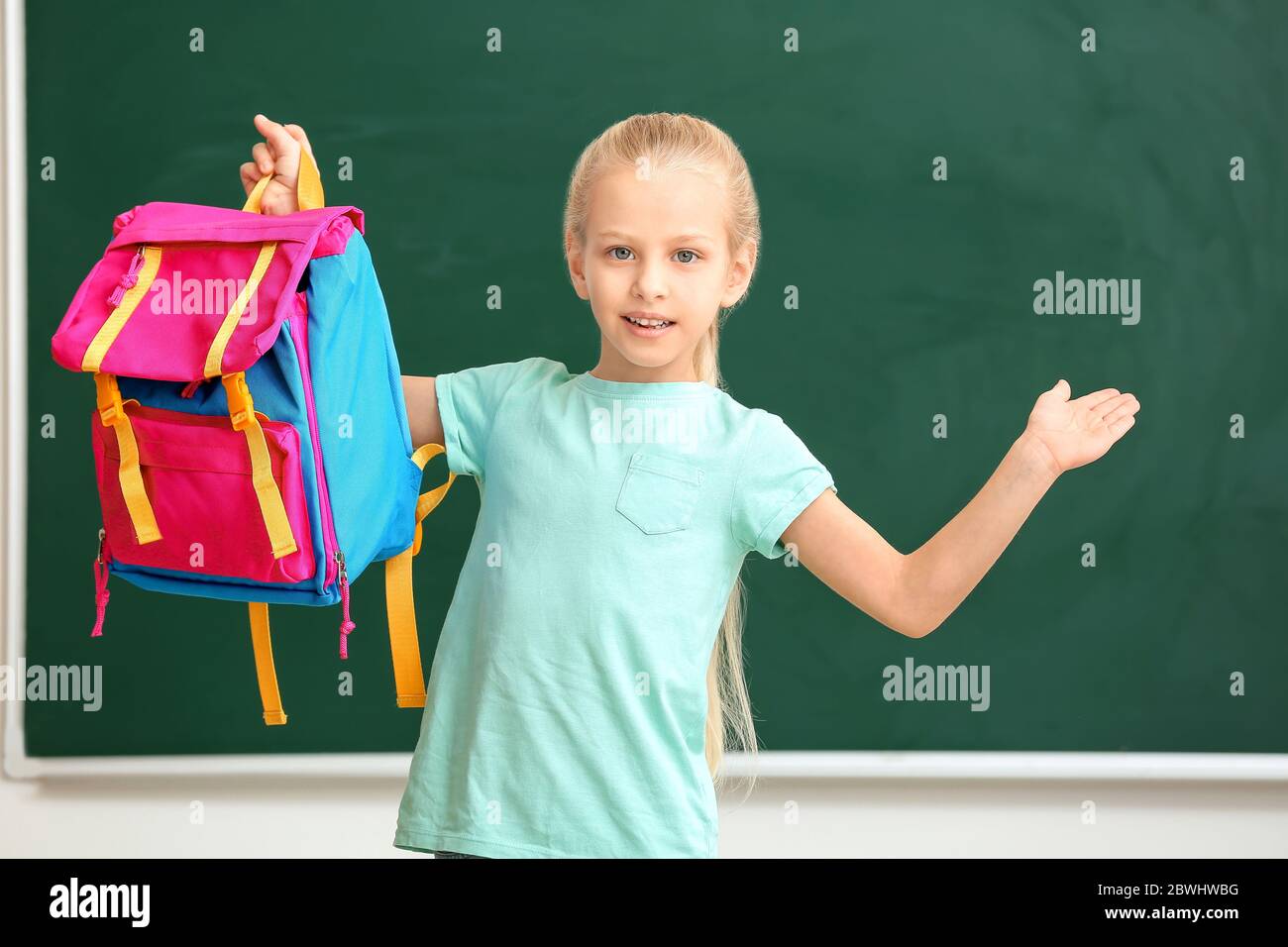 Cute little schoolgirl in classroom Stock Photo - Alamy