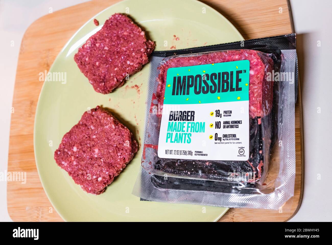 May 22, 2020 Sunnyvale / CA / USA - Impossible Burger patties and package on a plate; the Impossible Burger is produced by Impossible Foods Inc and is Stock Photo