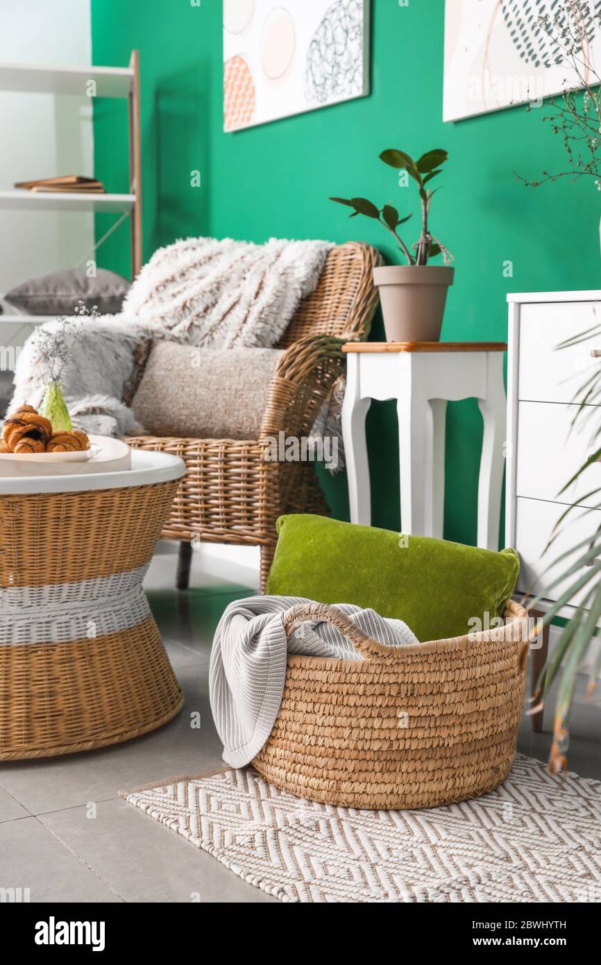 Stylish interior of living room with wicker furniture Stock Photo - Alamy