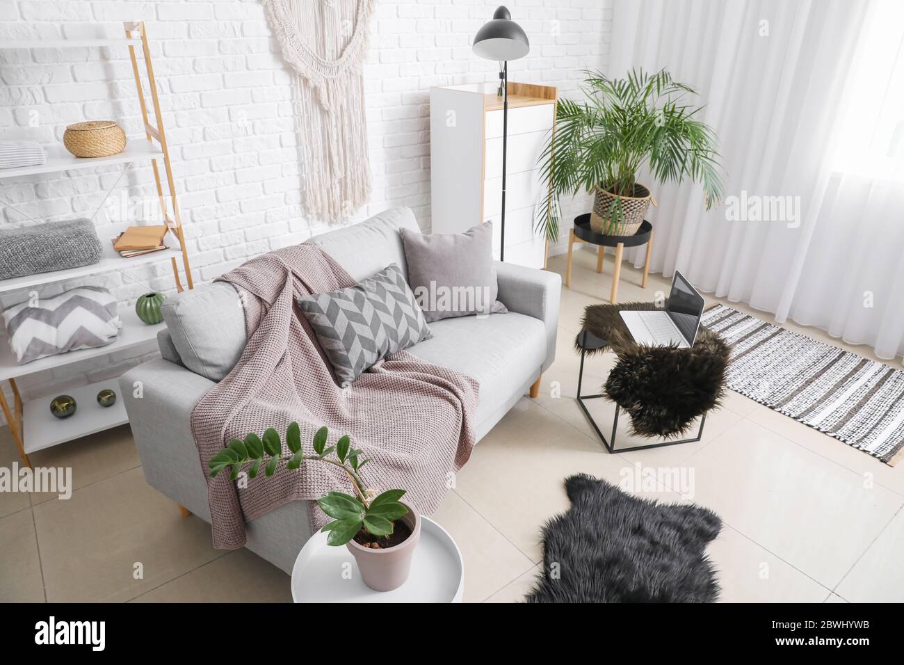 Stylish interior of living room with sofa Stock Photo - Alamy