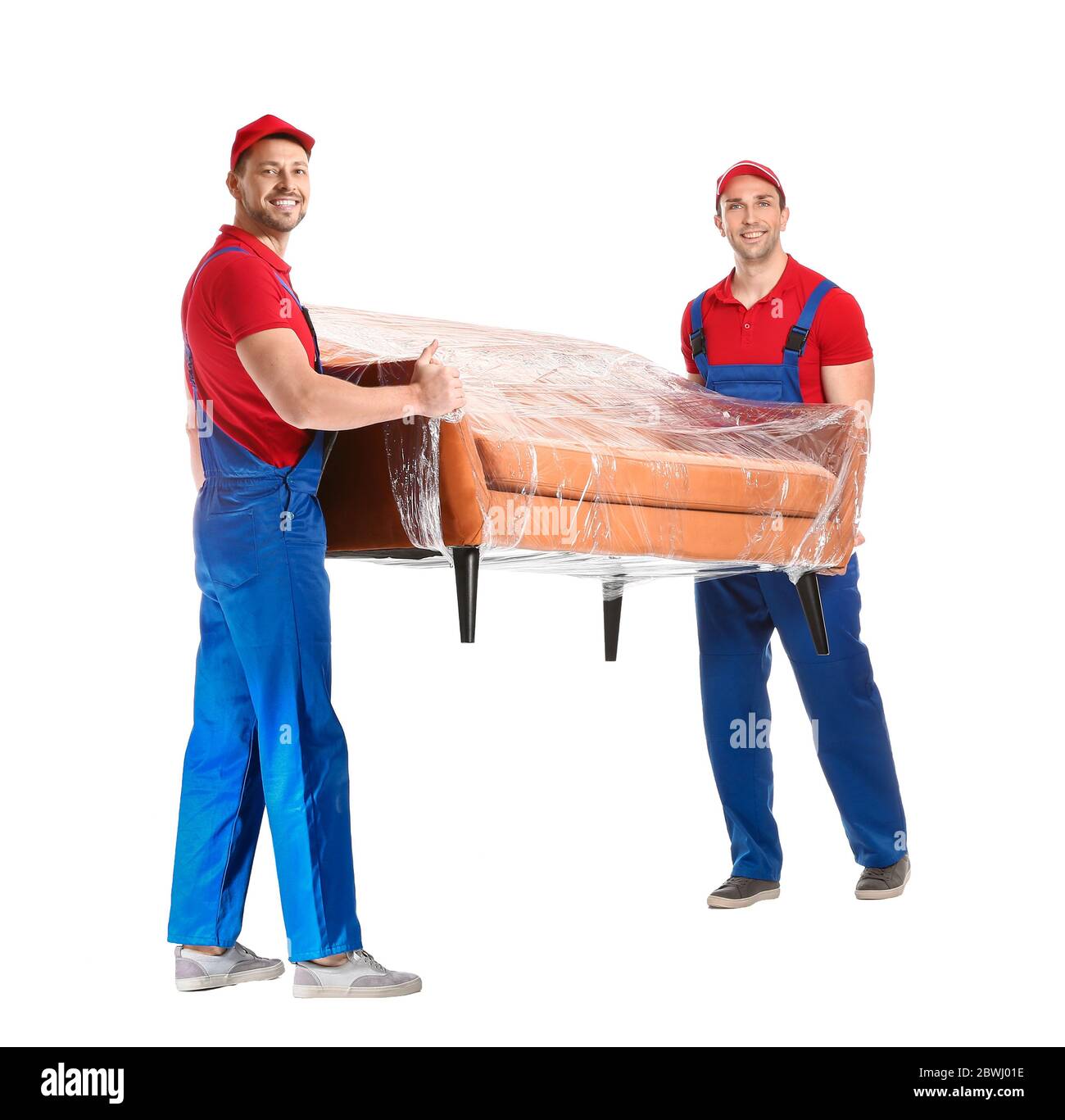 Loaders carrying furniture against white background Stock Photo Alamy