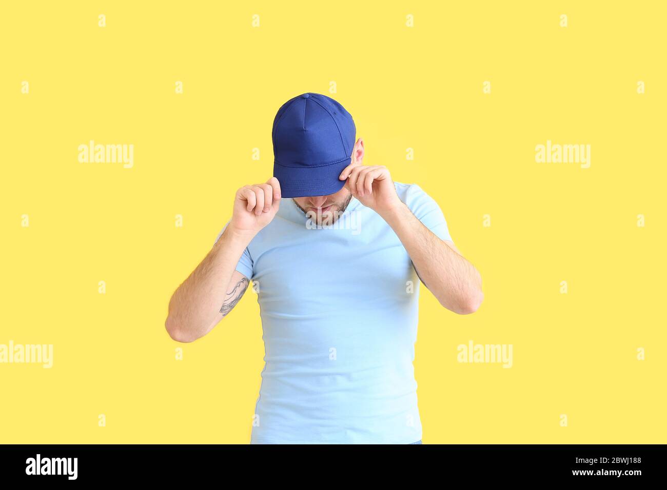 Download Handsome Man In Stylish Cap On Color Background Stock Photo Alamy PSD Mockup Templates