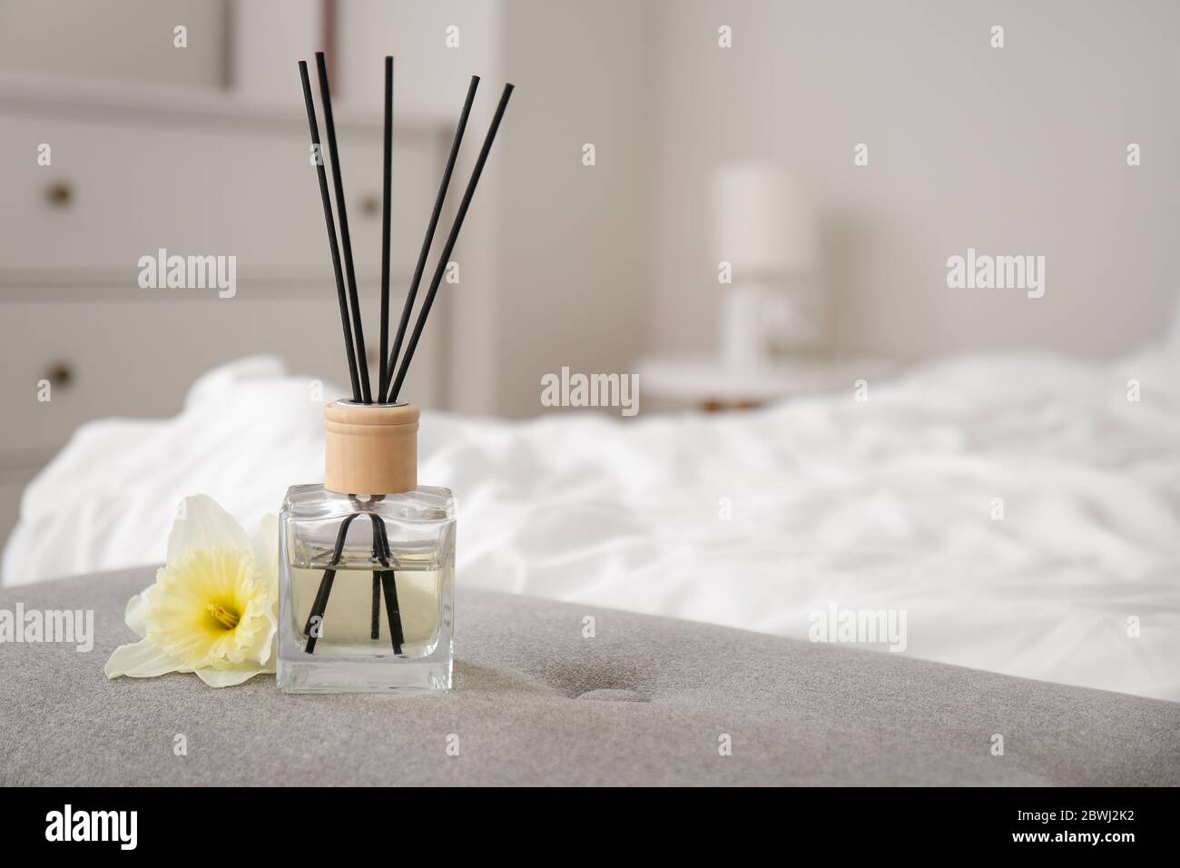 Reed diffuser on bedside bench in room Stock Photo - Alamy