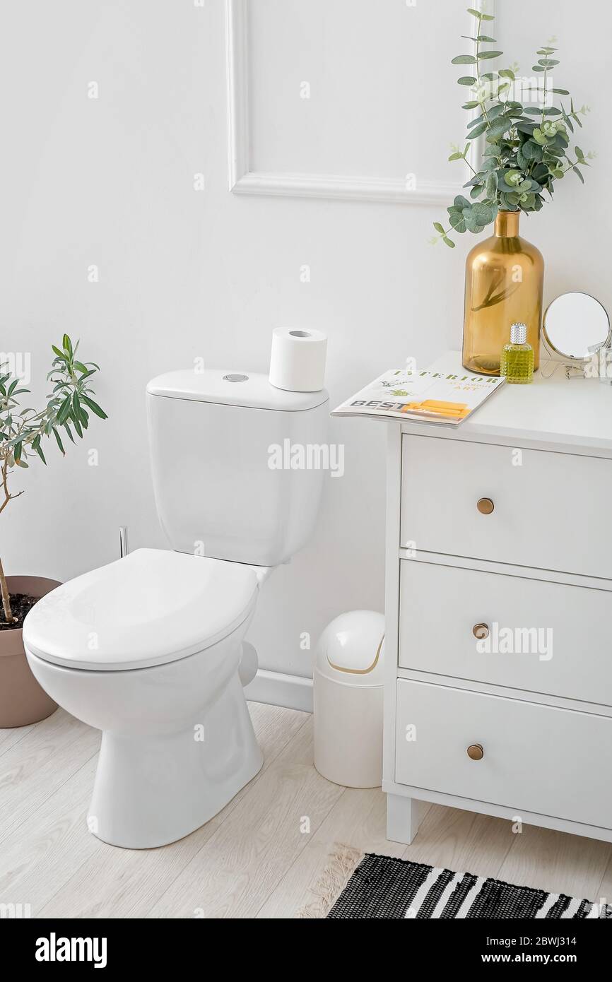 Toilet bowl in interior of light modern bathroom Stock Photo - Alamy