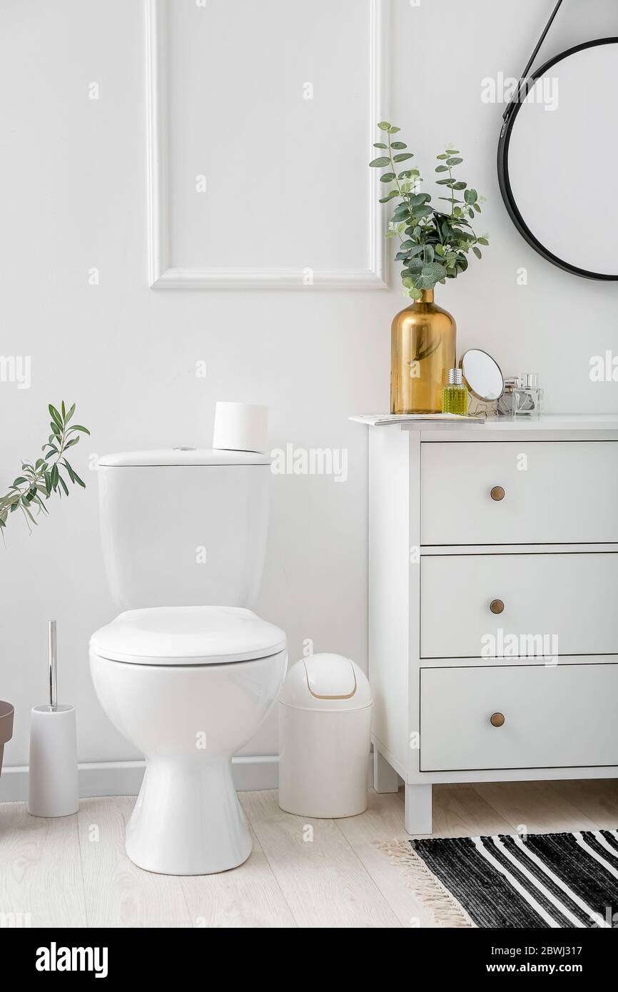 Toilet bowl in interior of light modern bathroom Stock Photo - Alamy