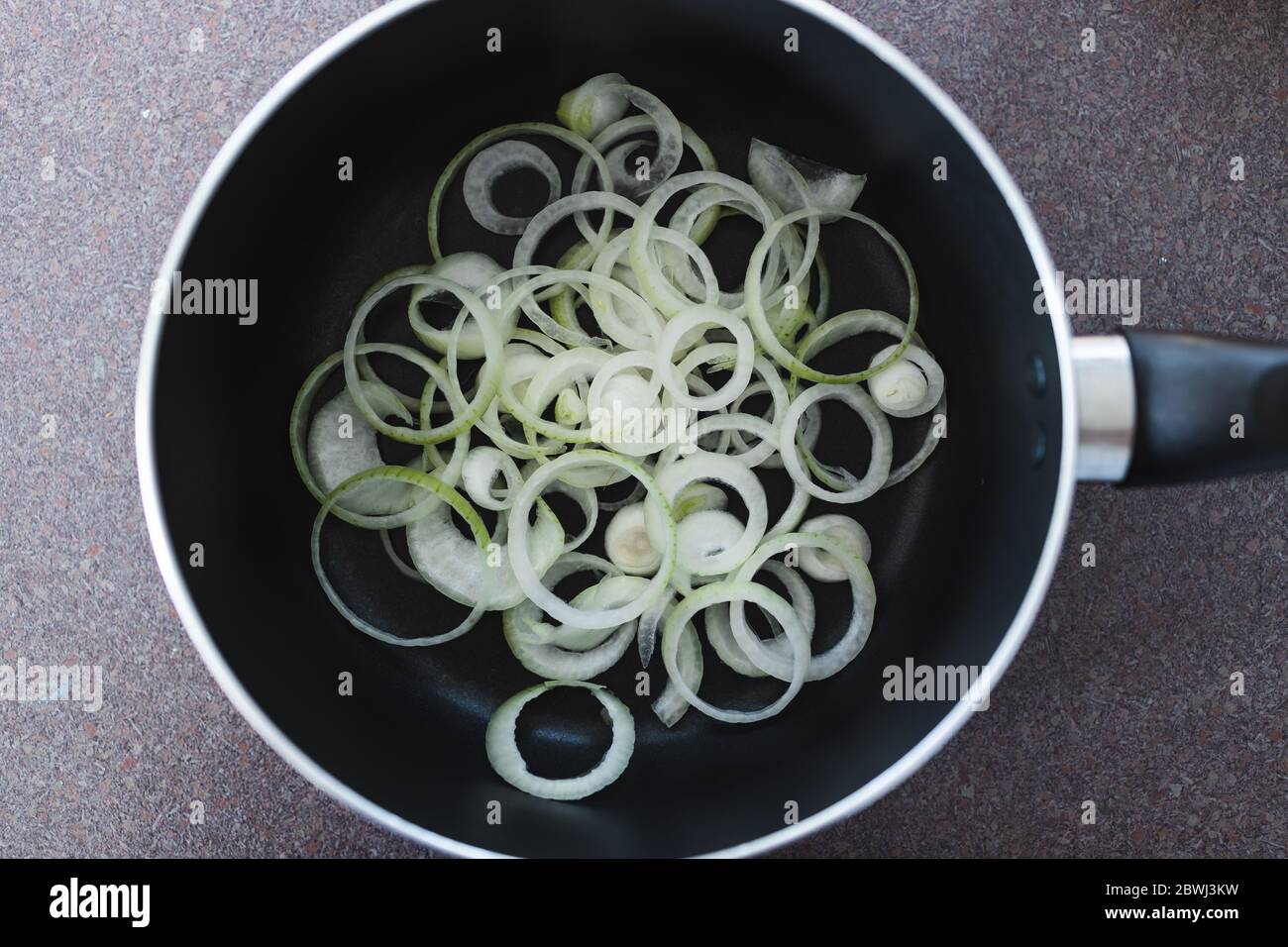 simple food ingredients concept, onion rings inside saucepan ready to ...