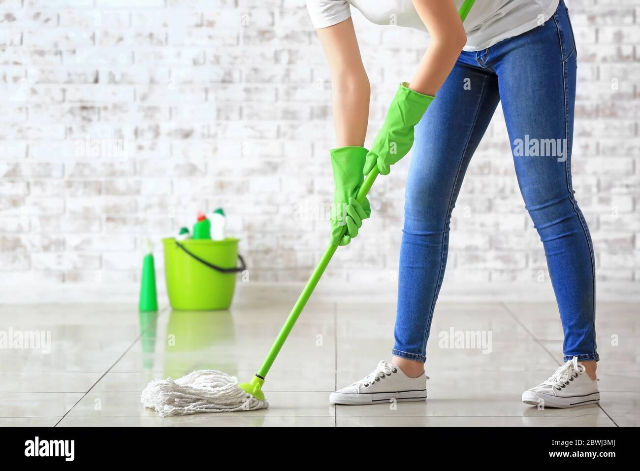 Woman mopping floor in room Stock Photo Alamy