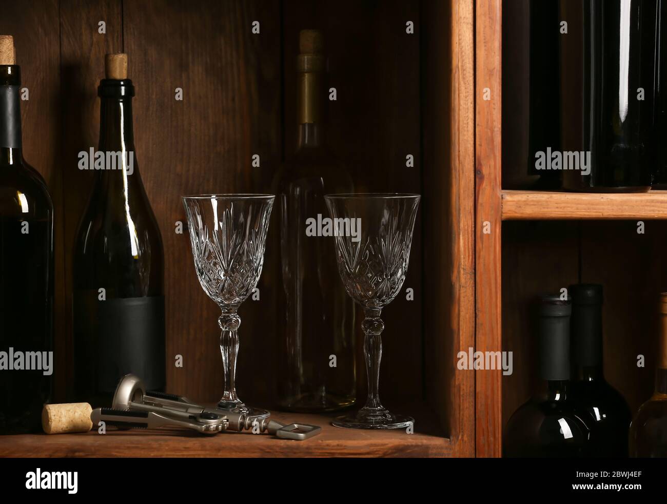 Bottles of wine and glasses in cellar Stock Photo Alamy