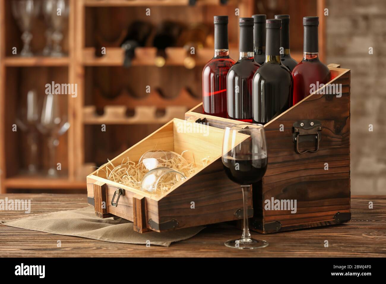 Box with bottles of wine on table in cellar Stock Photo - Alamy