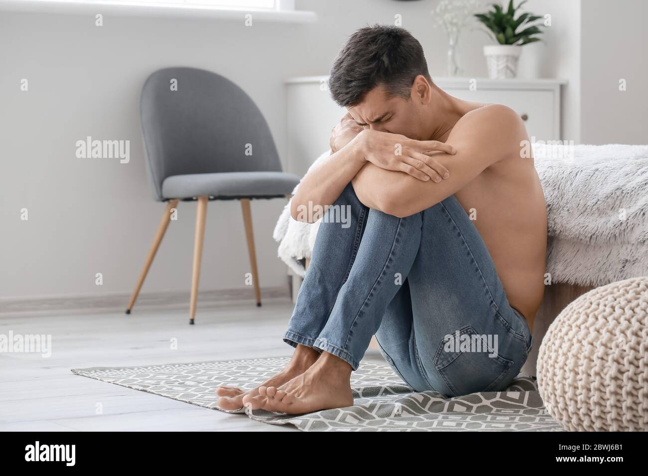 Young man suffering from anorexia at home Stock Photo
