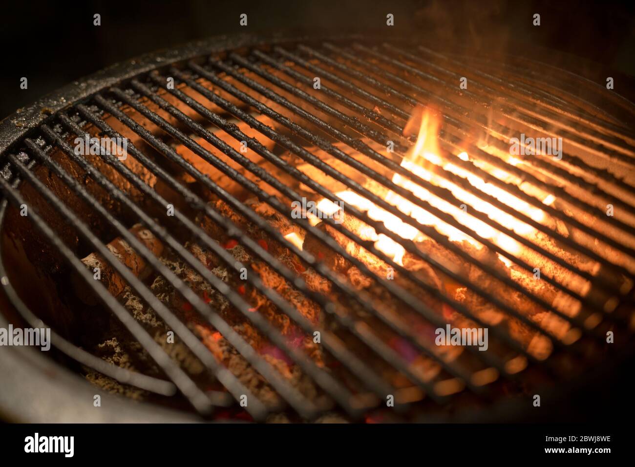 Barbecue fire with round grill. Food preparing concept with bbq fire on grill Stock Photo Alamy