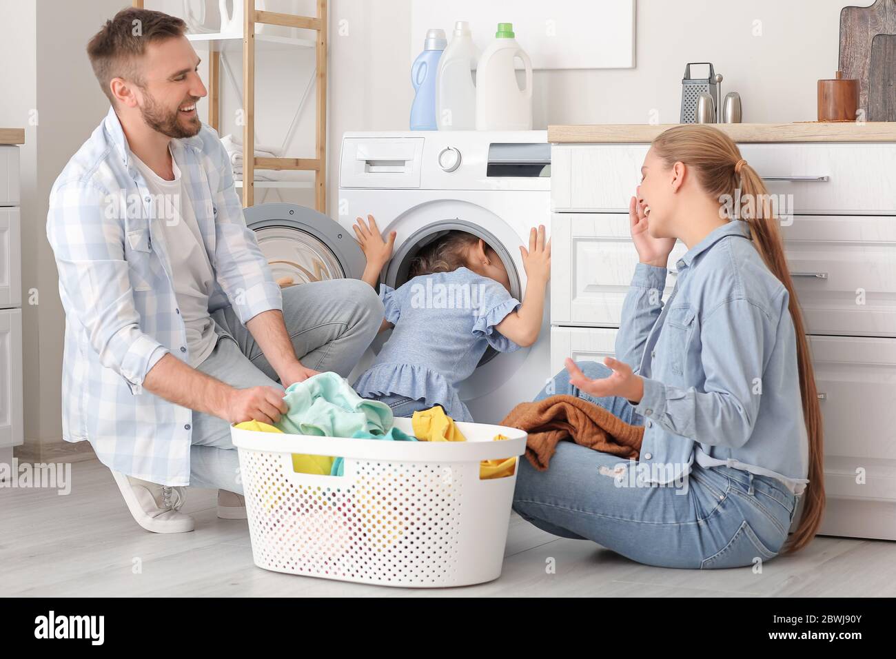 Family doing laundry at home Stock Photo Alamy