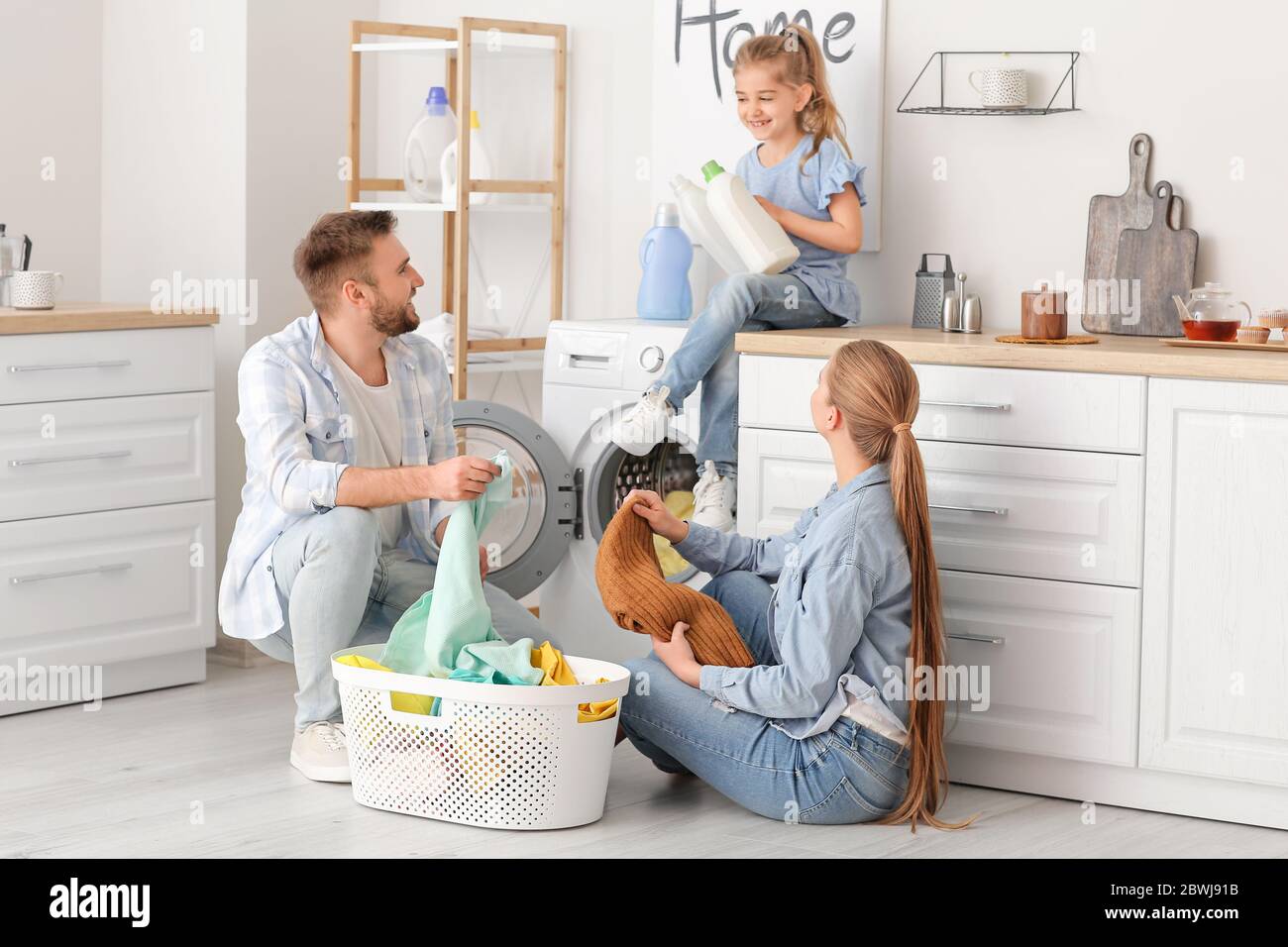 Family doing laundry at home Stock Photo Alamy