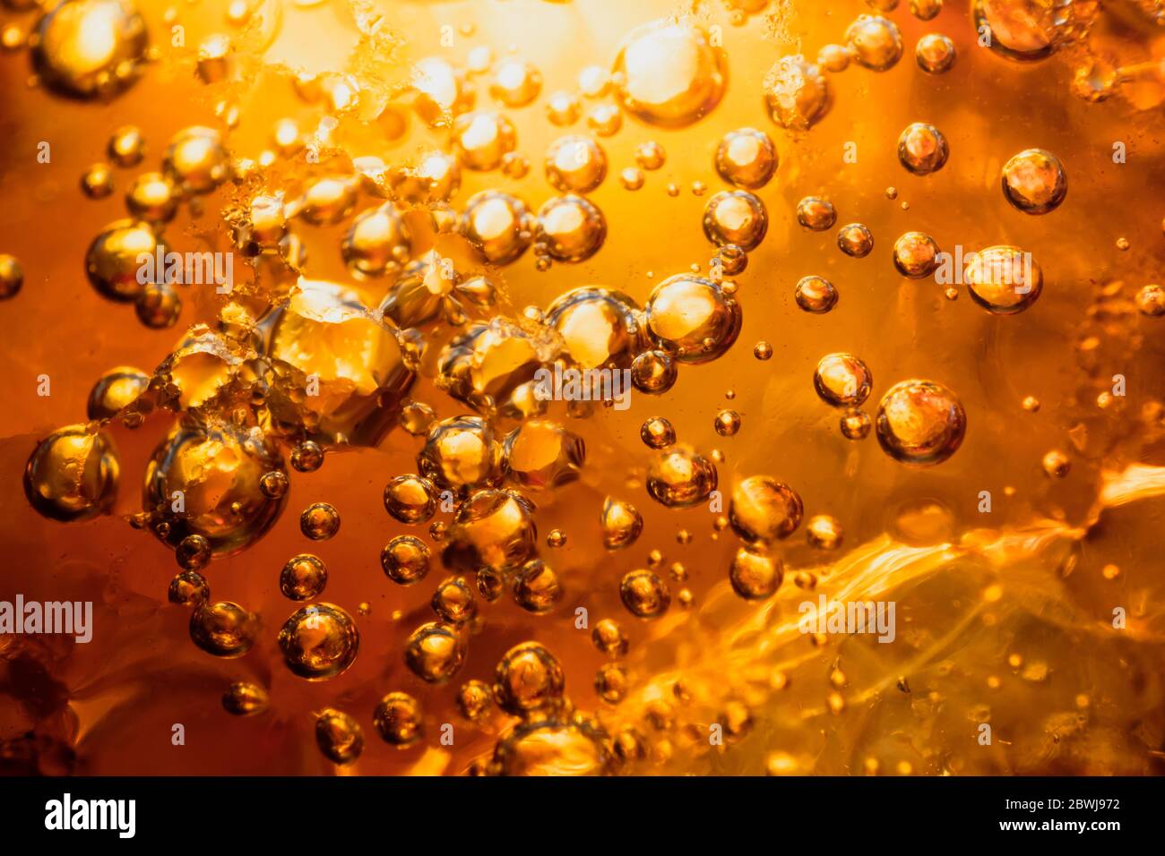 abstract water with bubbles soars over a golden background Stock Photo