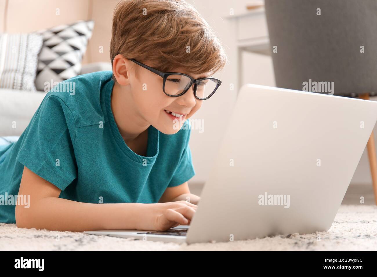 Cute little boy with laptop at home. Concept of online education Stock ...