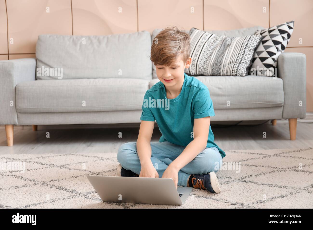 Cute little boy with laptop at home. Concept of online education Stock ...
