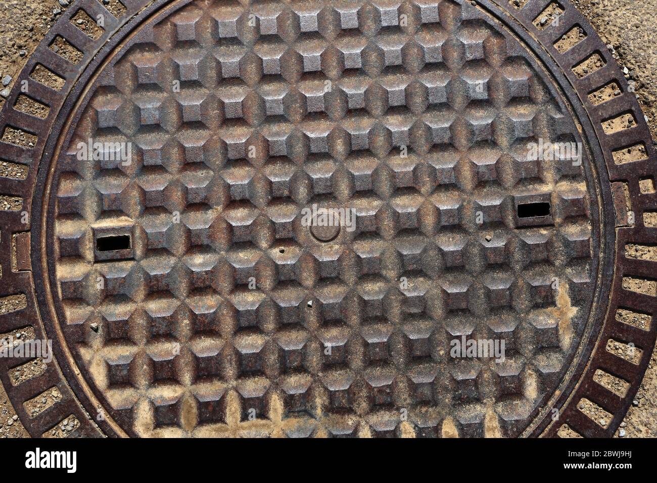 Old rusty metal street sewer drain cover top hatch texture Stock Photo
