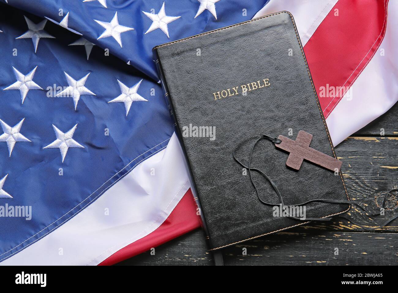 picture Bible American Flag And Cross https www alamy com holy bible cross and usa flag on wooden background image359976909 html