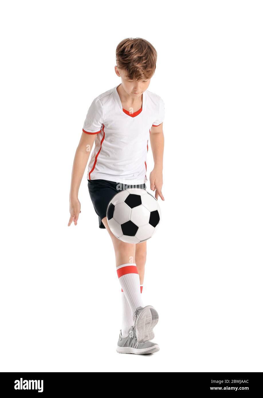 Cute little football player on white background Stock Photo - Alamy